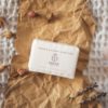 Crown Chakra Soap, wrapped on crumpled brown paper with scattered rose buds, lavender petals and rose quartz | Shine Body & Bath